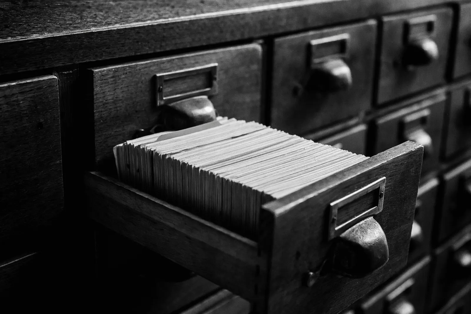 Open card catalog drawer, dense rows of index cards